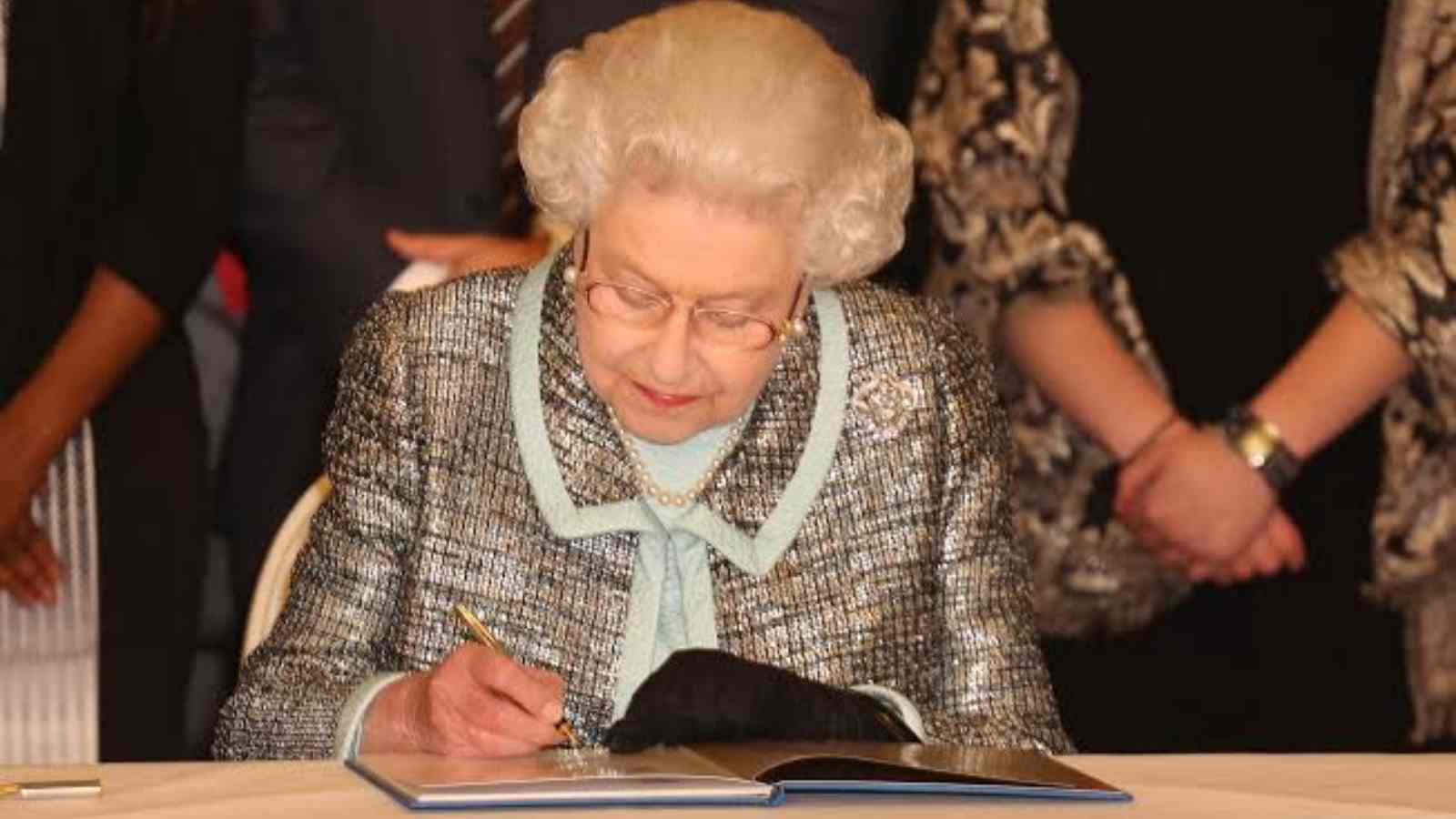 Queen Elizabeth II signing a document