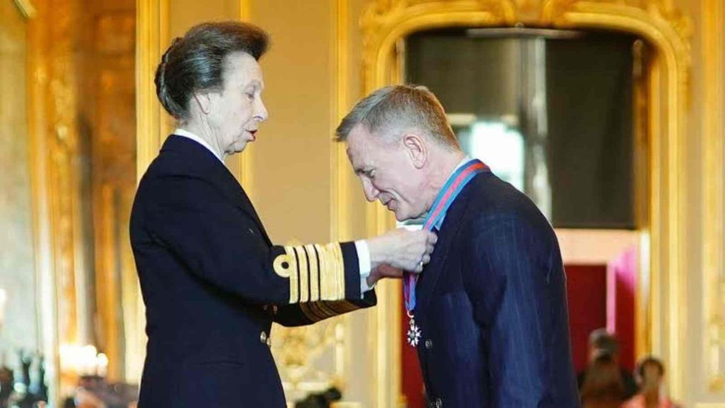 Daniel Craig being honored with the Order of St. Michael and St. George by Princess Anne