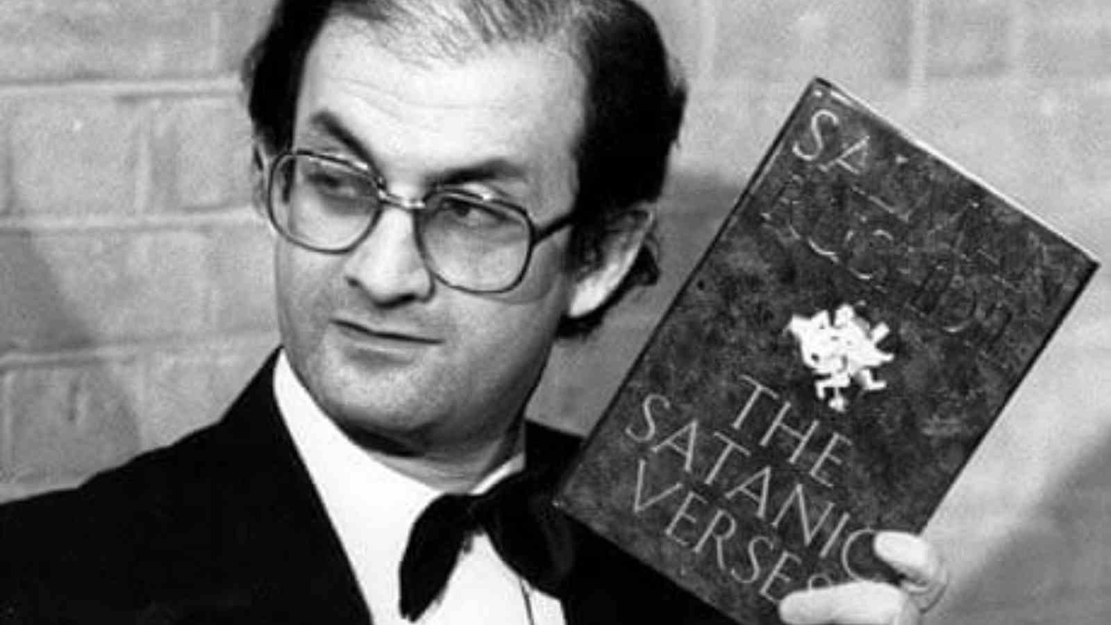 Salman Rushdie holding his book 'Satanic Verses'