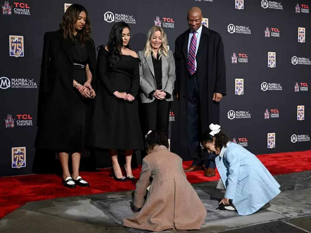 Capri and Bianka Bryant imprint their hands on Kobe's prints while Vanessa and Natalia Bryant watch