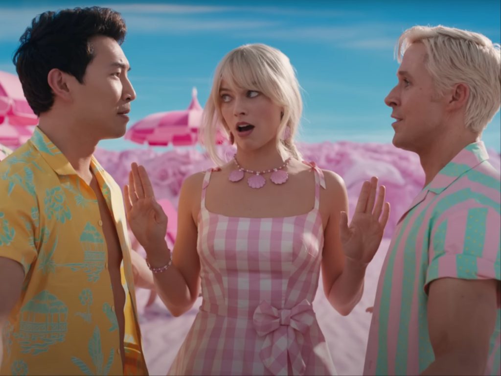 A still from 'Barbie' featuring Simu Liu, Margot Robbie, and Ryan Gosling.