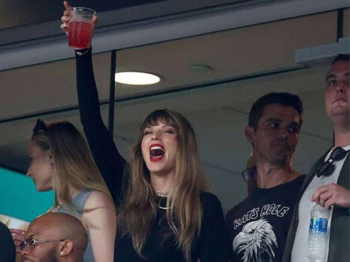 Taylor Swift cheers for Travis Kelce as she attends the Kansas City Chiefs game with her entourage