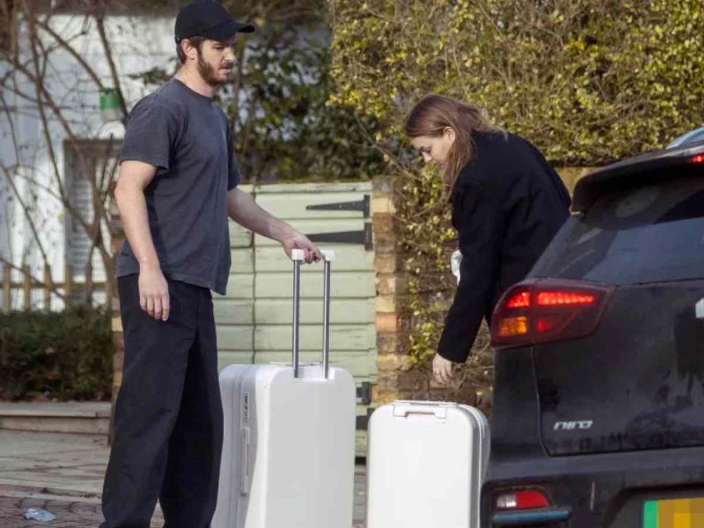 Andrew helps load Olivia's luggage into a taxi before waving her off