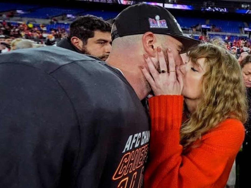Taylor Swift and Travis Kelce share a kiss after the Kansas City Chiefs qualified for the Super Bowl