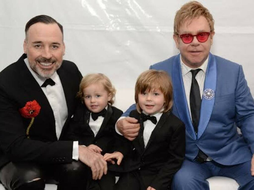 Elton and his husband with their children