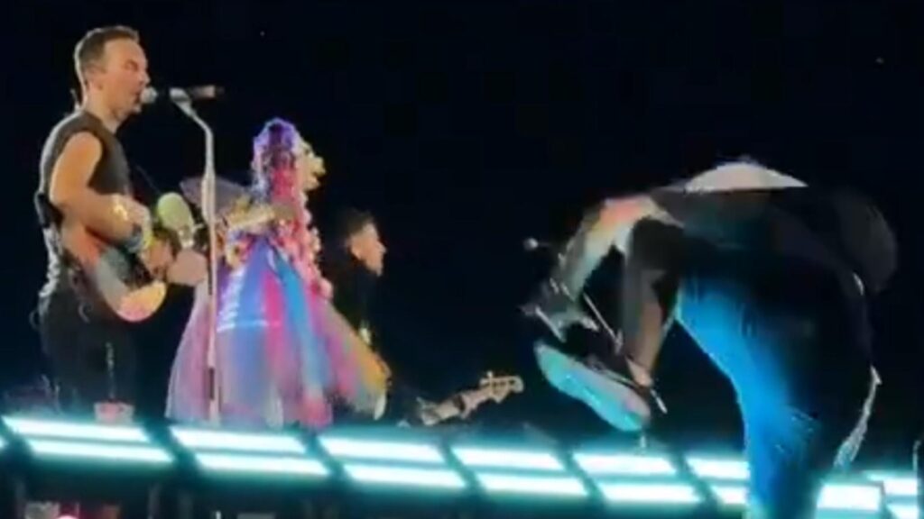 A still from the footage of the fan attempting to crash the stage and falling