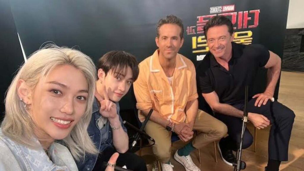 Stray kids members with Ryan Reynolds and Hugh Jackman