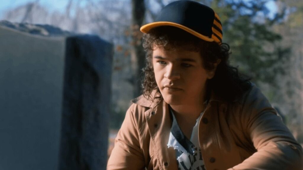 Dustin in front of Eddie's tomb in Stranger Things, Season 5